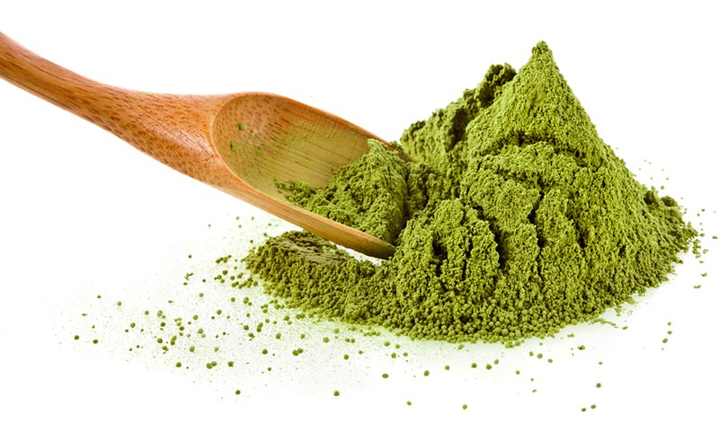 Powdered greens and bamboo spoon